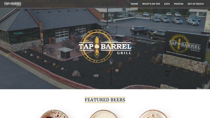 Tap & Barrel home page: an aerial view of the restaurant under its gold badge logo.